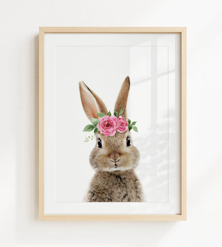 A framed image of a rabbit wearing a pink flower crown.