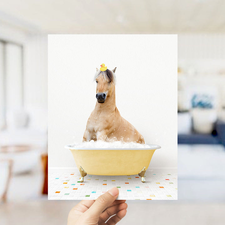 A brown horse sitting in a yellow bathtub filled with bubbles, wearing a yellow rubber duck on its head.