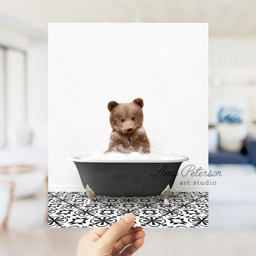 a person holding up a picture of a teddy bear in a bathtub