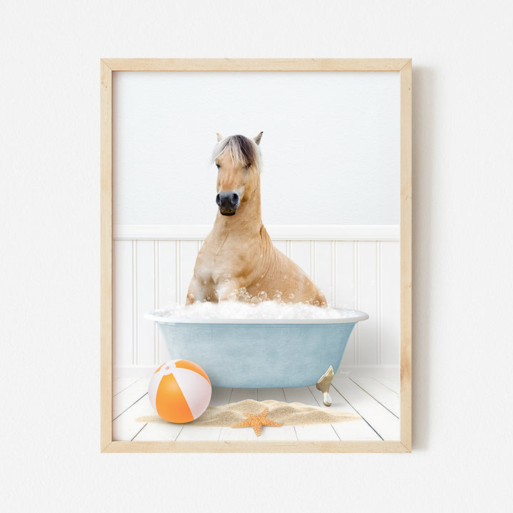 a horse in a bathtub with a beach ball