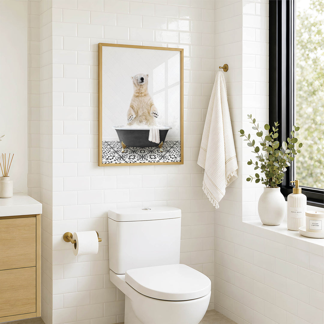 A bathroom with a white toilet, a framed picture of a polar bear sitting in a bathtub, and a window with greenery on the sill.