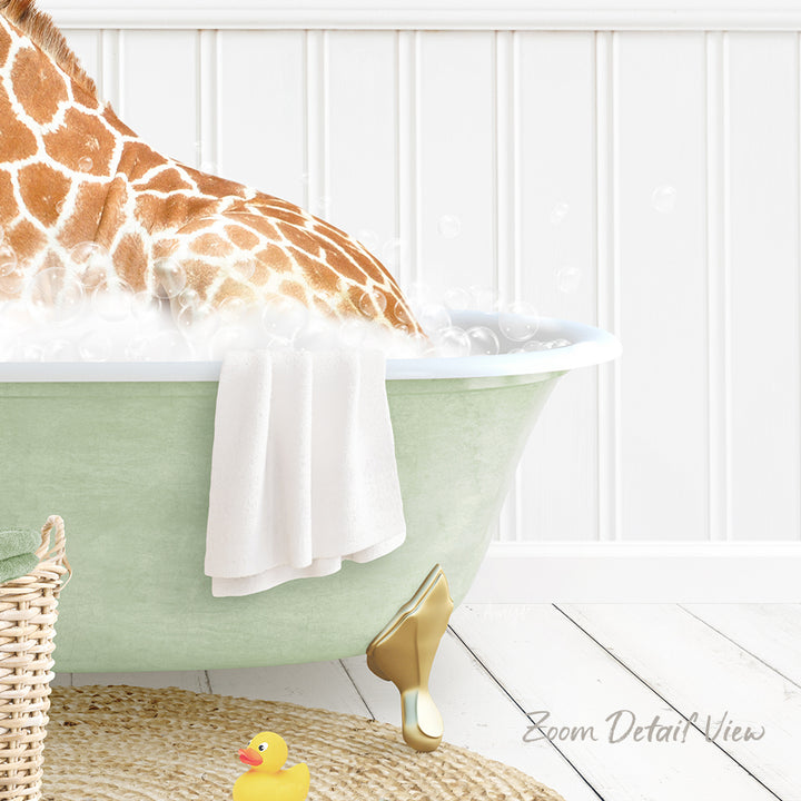 A giraffe is sitting in a green bathtub filled with water, surrounded by a yellow rubber duck and a white towel.