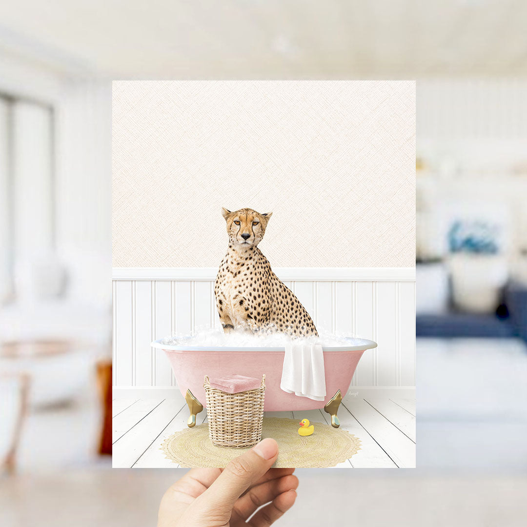 A cheetah sitting in a pink bathtub filled with bubbles, with a yellow rubber duck nearby.