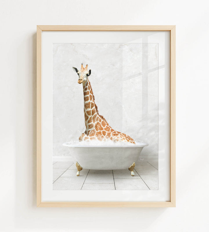 A giraffe is sitting in a white bathtub, surrounded by bubbles, in the image.