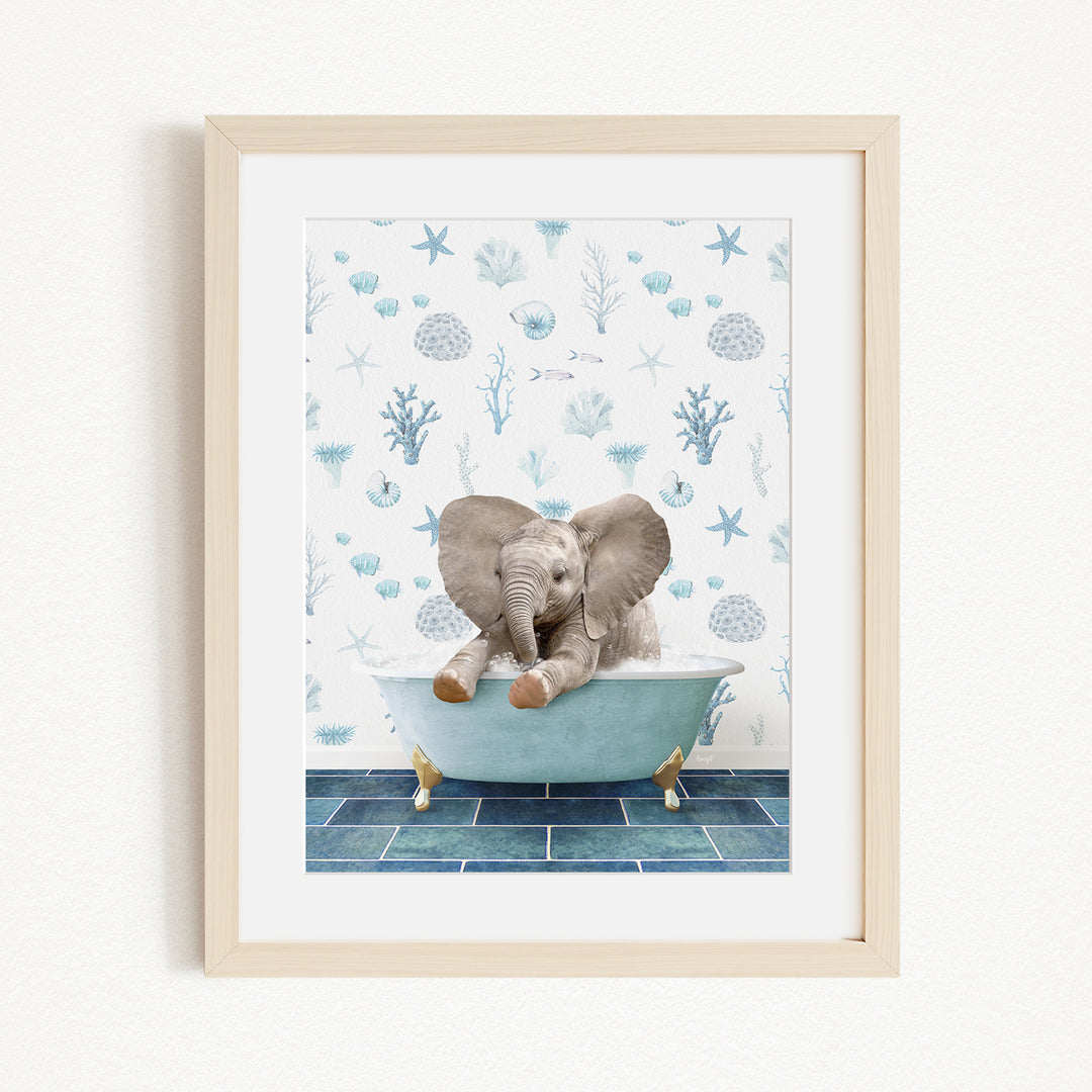 A framed image depicting a baby elephant sitting in a bathtub filled with water, surrounded by blue and white seashells and starfish.