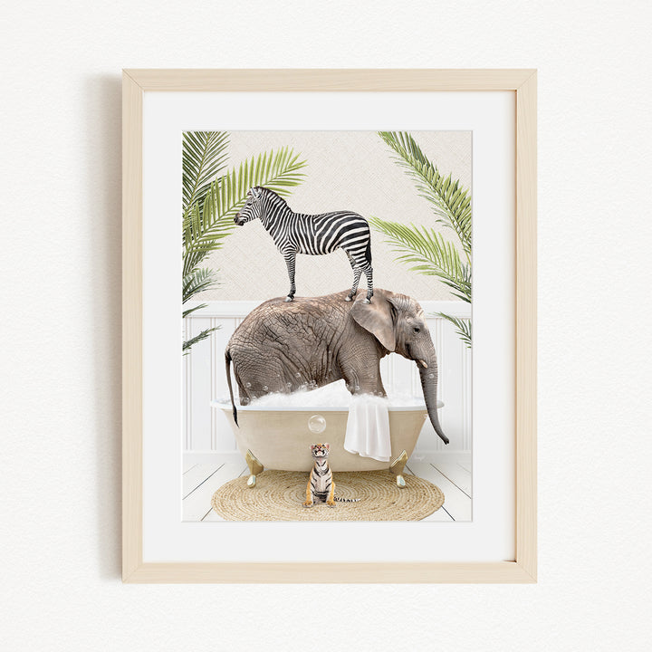A framed image depicting a zebra standing on an elephant's back while the elephant is submerged in a bathtub, with a tiger sitting on the edge of the tub.
