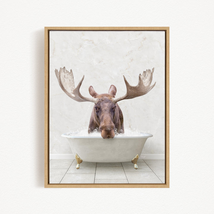 A moose with large antlers is sitting in a bathtub filled with water, creating a whimsical and humorous scene.