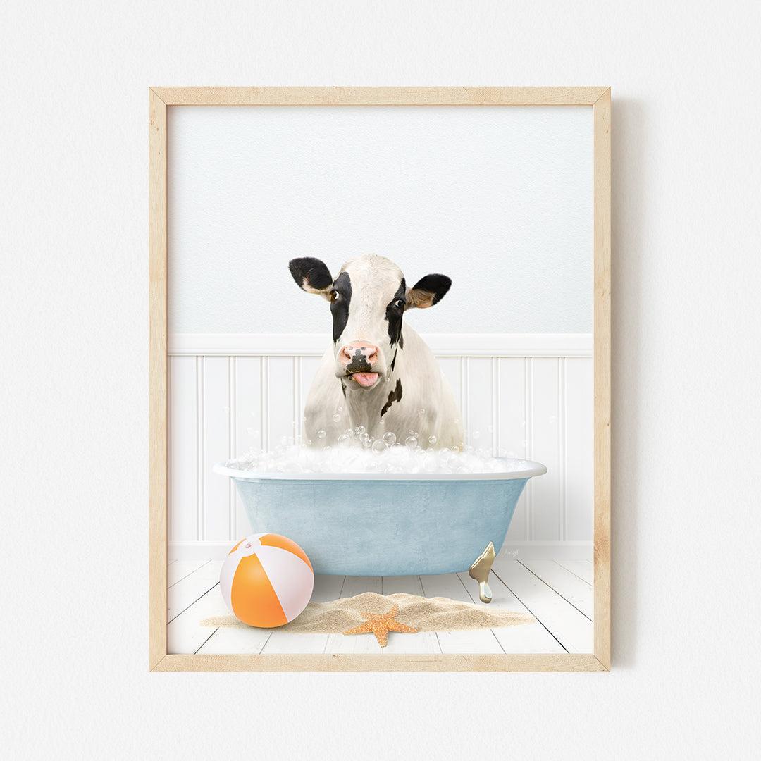 a cow in a bathtub with a beach ball