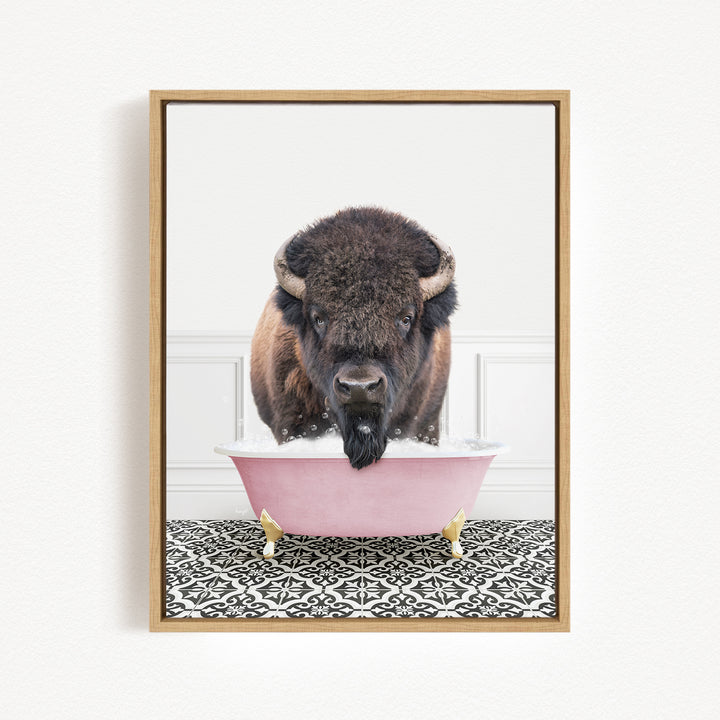 A buffalo with large horns is standing in a pink bathtub filled with water, creating a whimsical and playful scene.