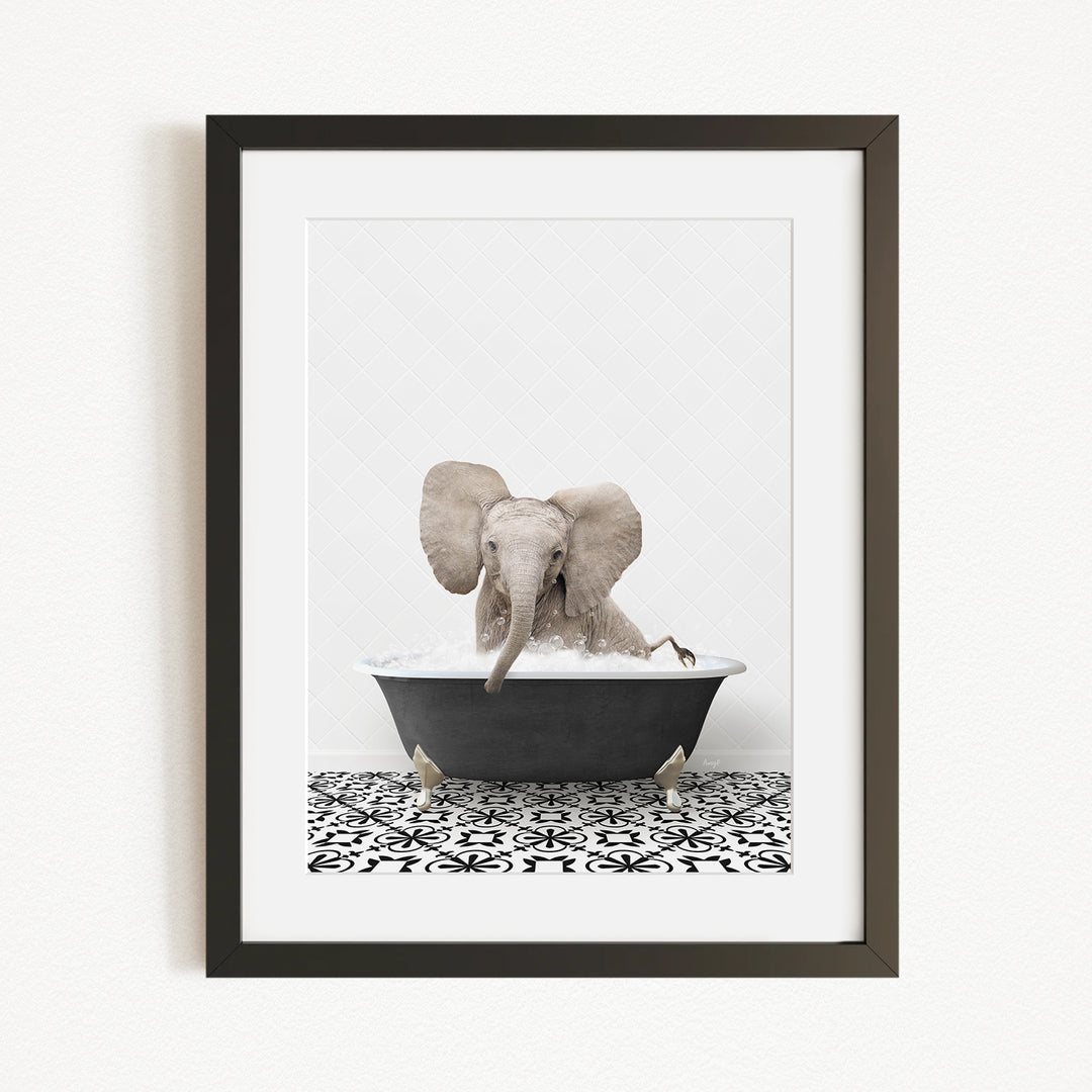 A framed image of an elephant sitting in a bathtub filled with water, surrounded by a black and white patterned floor.