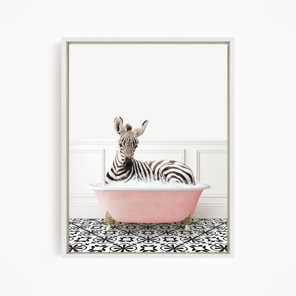 A zebra is sitting in a pink bathtub, surrounded by a black and white patterned floor.
