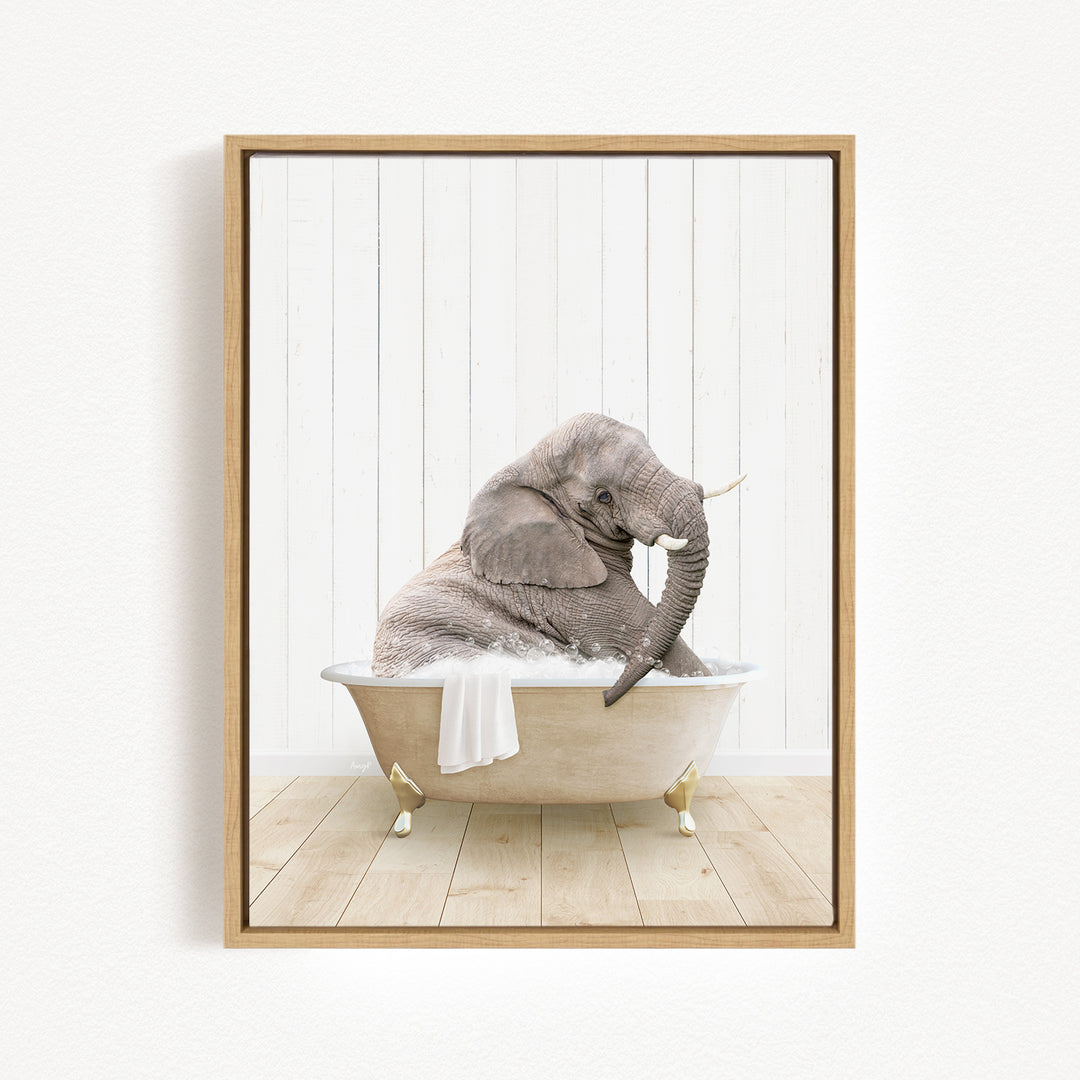A gray elephant sitting in a white bathtub, with its trunk raised and a towel draped over its back.