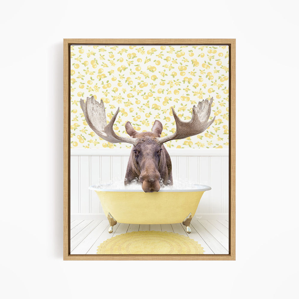 A moose with large antlers is sitting in a yellow bathtub, surrounded by a yellow floral pattern on the wall behind it.
