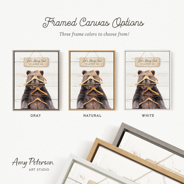 three framed canvas options, each featuring a bear wearing a hat and holding a pair of clothes hangers. The options include a gray, a natural, and a white frame.