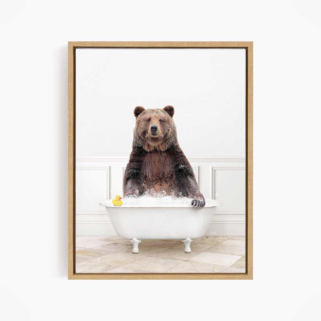 A brown bear sitting in a white bathtub, with a yellow rubber duck floating on the water.