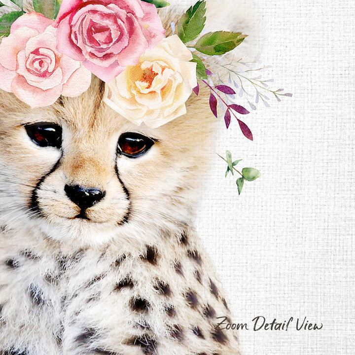 A close-up of a cheetah's face, adorned with a floral crown of pink and yellow roses and green leaves.