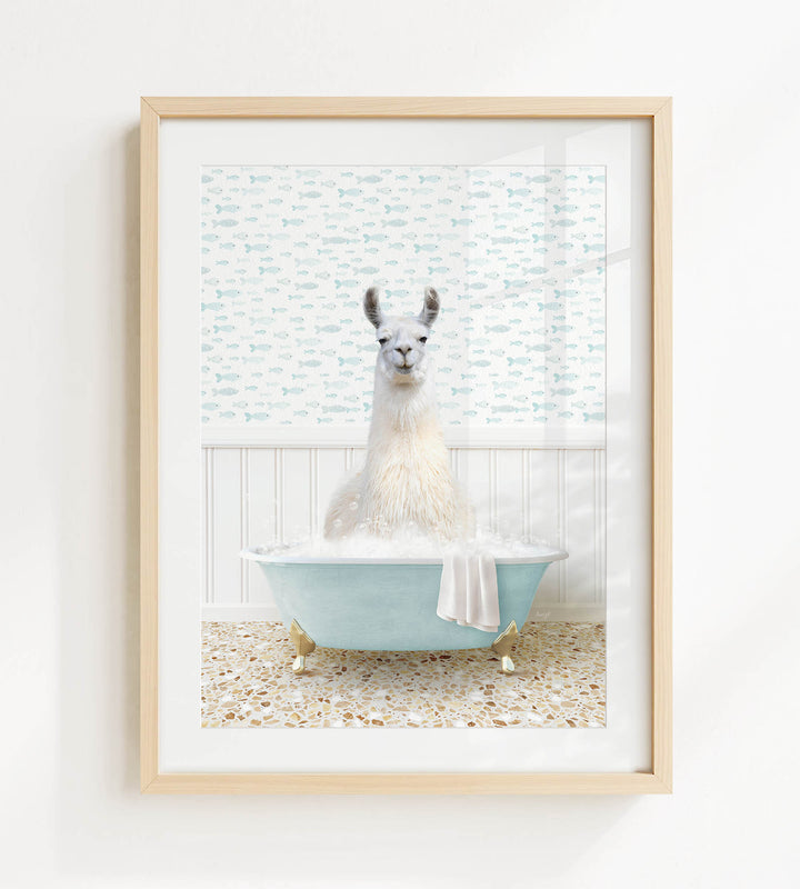 A white llama sitting in a blue bathtub filled with bubbles, surrounded by a patterned wall and a window.