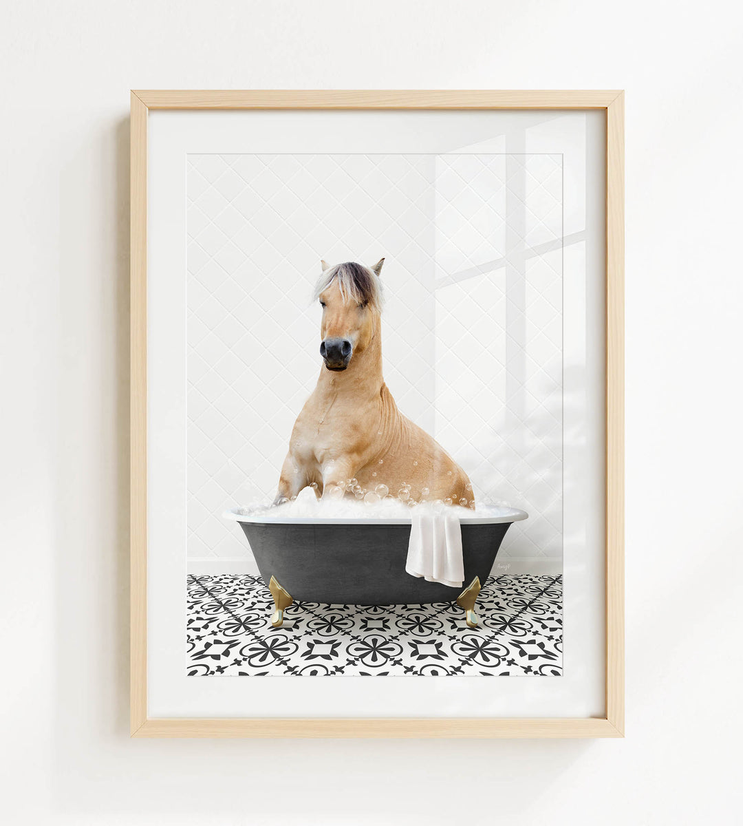 A light brown horse sitting in a black bathtub filled with water, surrounded by a black and white patterned floor.