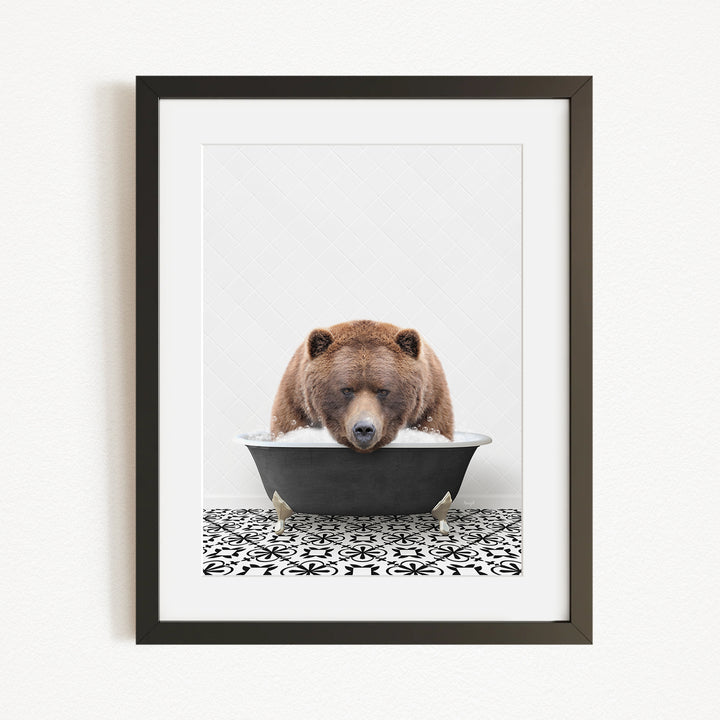 A brown bear is sitting in a bathtub filled with water, appearing to be enjoying a relaxing bath.
