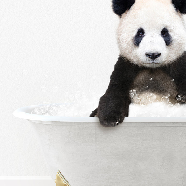 a panda bear sitting in a bathtub with bubbles