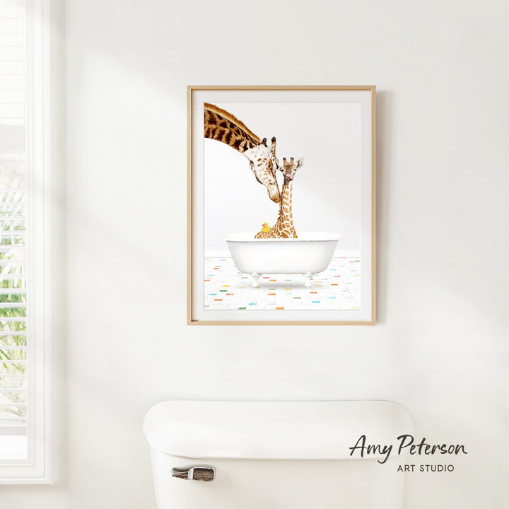 A framed painting of two giraffes in a white bathtub is hanging on a white wall.