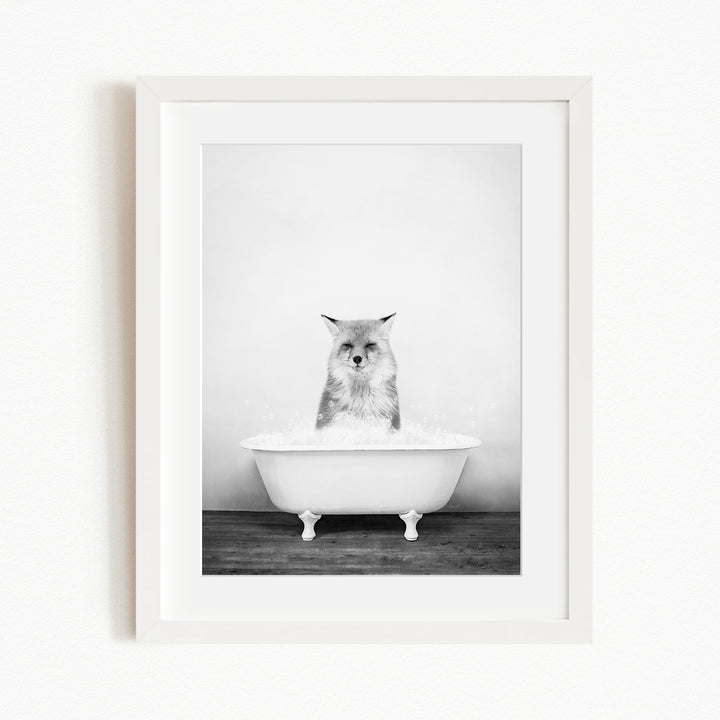 A cat sitting in a white bathtub filled with water, looking directly at the camera.