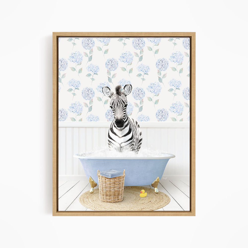 A zebra sitting in a blue bathtub filled with water, surrounded by a wicker basket and rubber duckies.