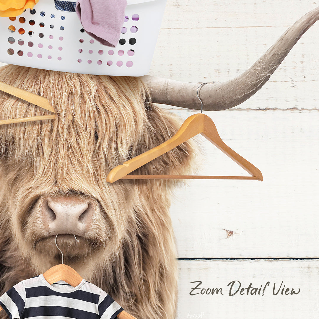 A large, shaggy-haired animal with a horn on its head, wearing a striped shirt and holding a wooden hanger, with a laundry basket and clothes hanging nearby.
