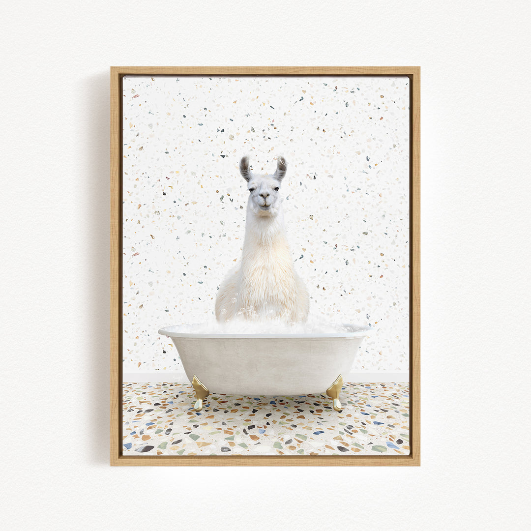 A white llama sitting in a white bathtub filled with water, surrounded by a speckled tiled floor.