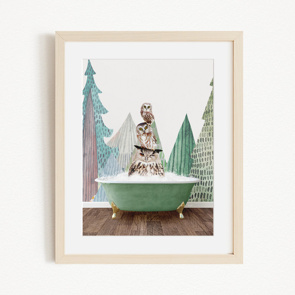 A framed image depicting a bird perched on a green bathtub, surrounded by stylized trees and a snowy landscape.