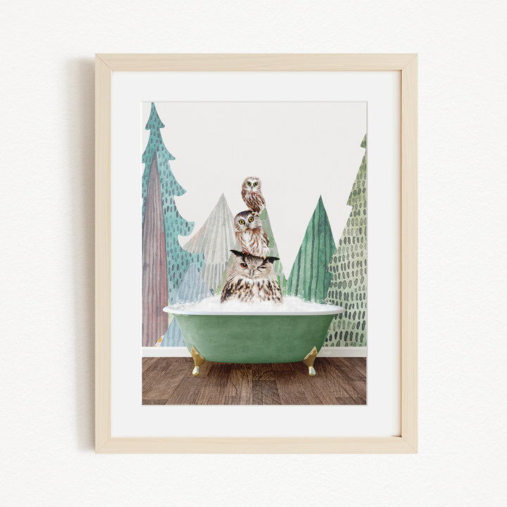 A framed image depicting a bird perched on a green bathtub, surrounded by stylized trees and a snowy landscape.