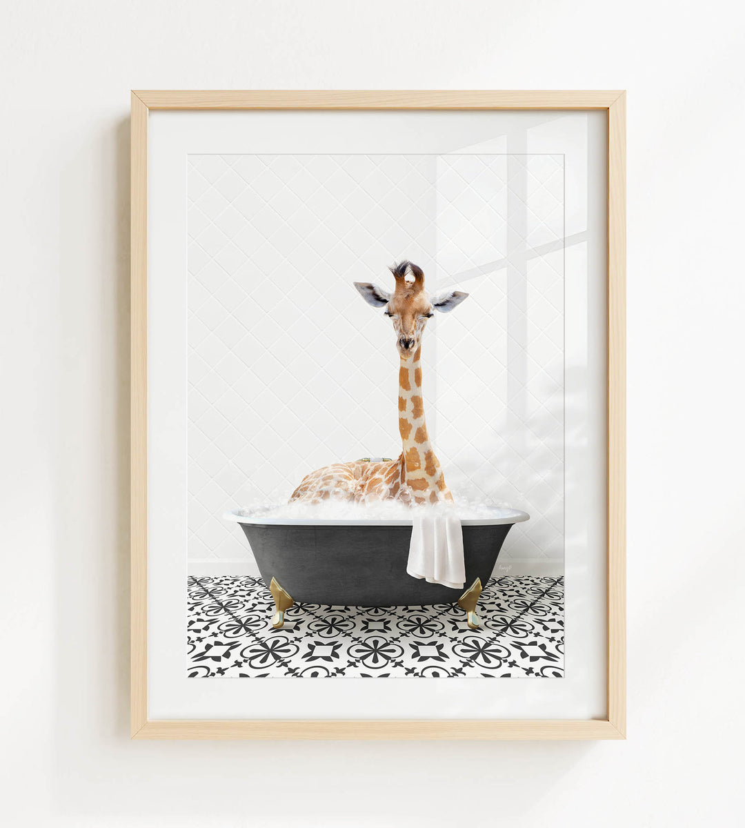 A giraffe is sitting in a black bathtub filled with bubbles, creating a whimsical and playful scene.