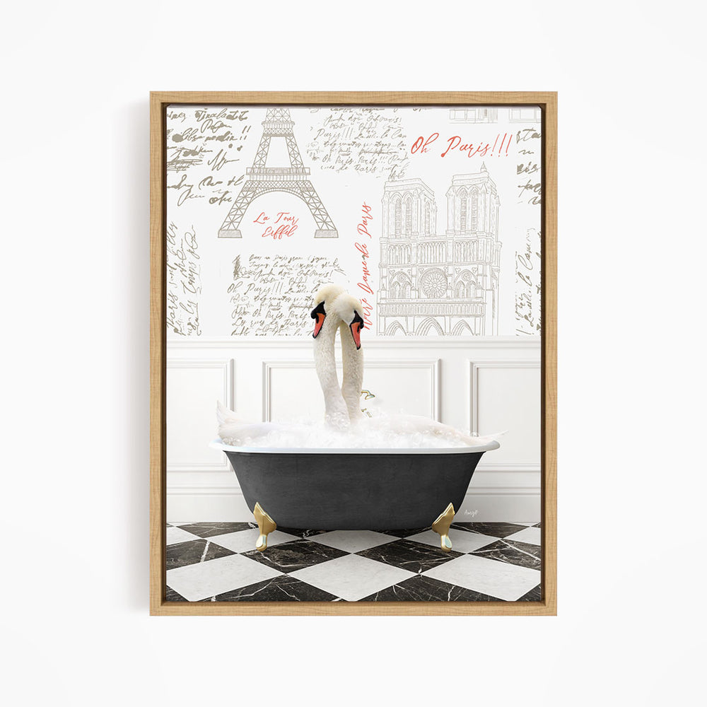 A framed image depicting two swans sitting in a bathtub, with a backdrop of the Eiffel Tower and other Parisian landmarks.