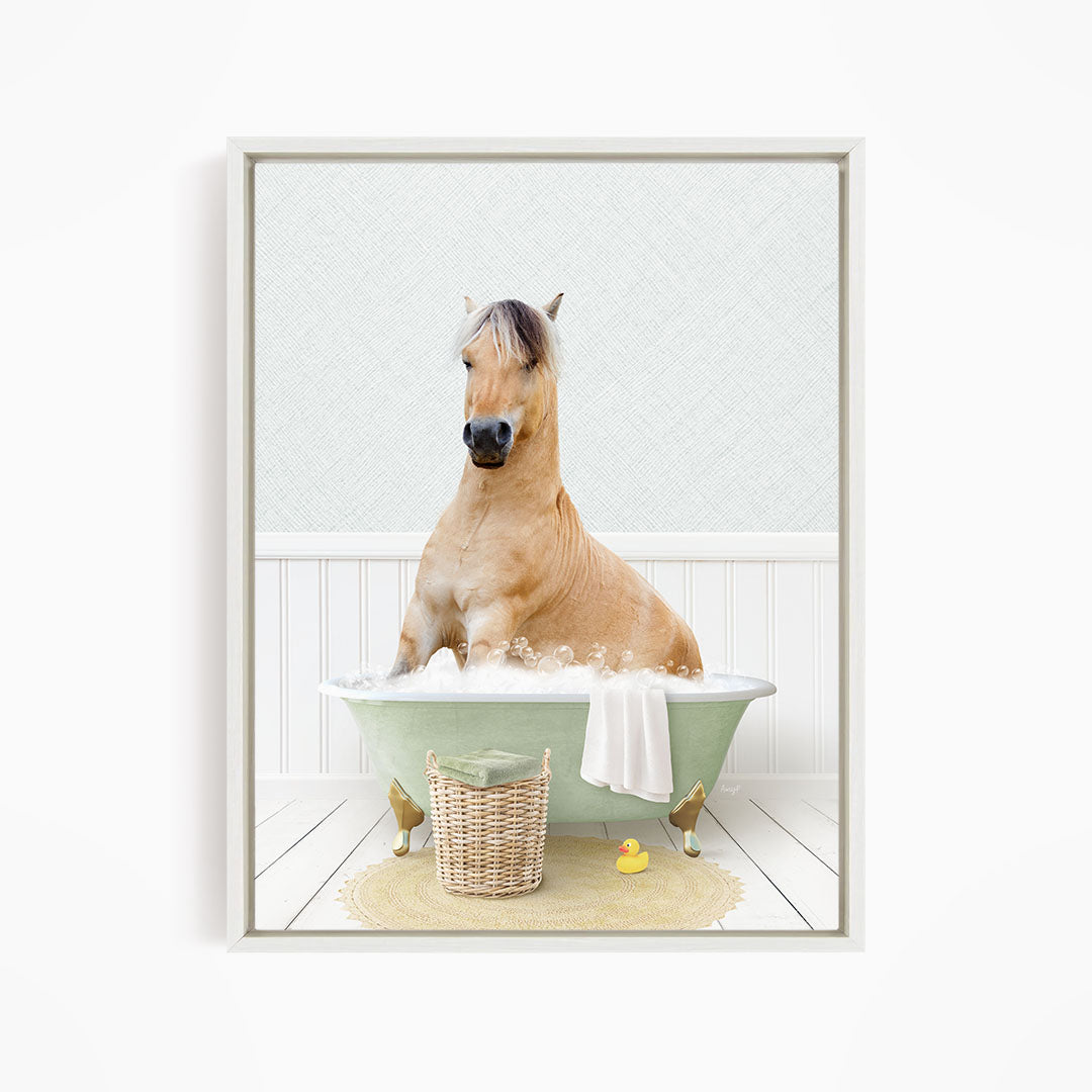 A light brown horse is sitting in a green bathtub filled with water, surrounded by a yellow rubber duck and a basket.