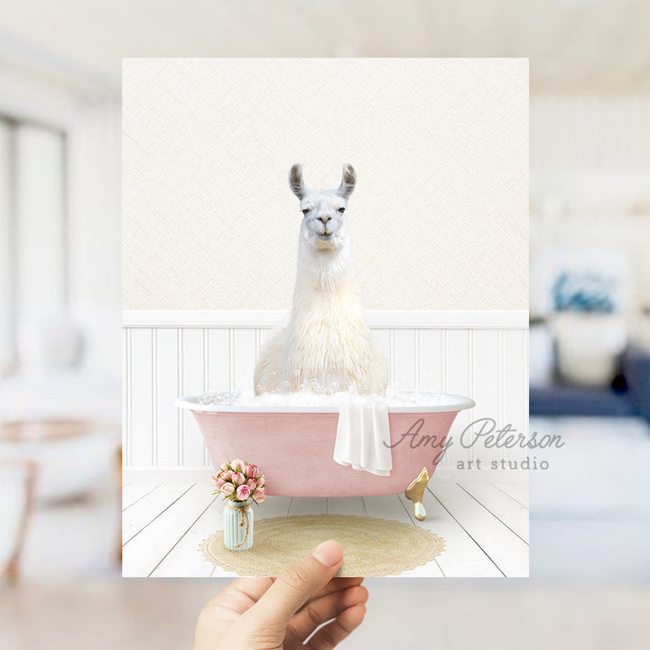 a person holding a card with a llama in a bathtub