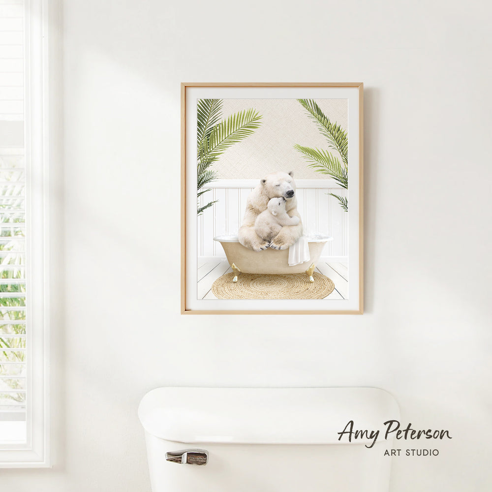 A framed image of a polar bear sitting in a bathtub, surrounded by palm leaves, is hanging on a white wall.