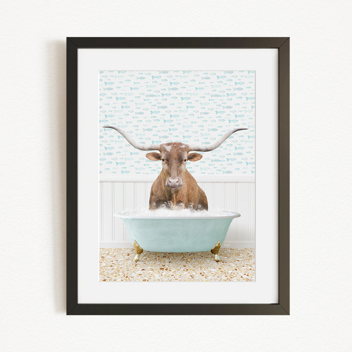 A brown cow with large horns is sitting in a light blue bathtub filled with water, surrounded by a patterned wall.