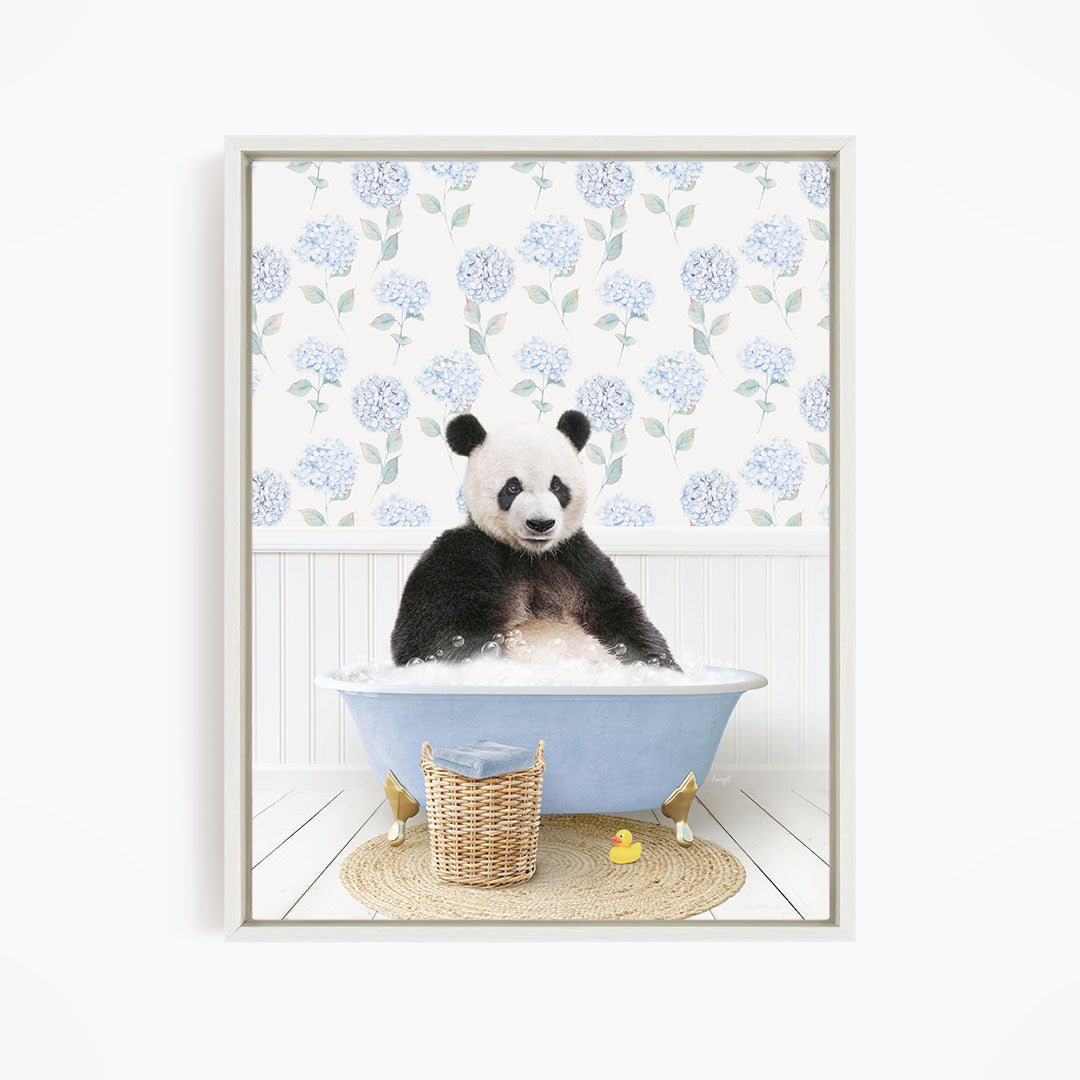 A panda bear sitting in a blue bathtub, surrounded by a wicker basket and a yellow rubber duck.