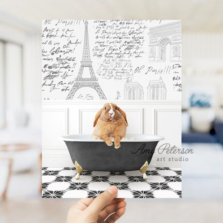 a person holding up a card with a picture of a rabbit in a bathtub