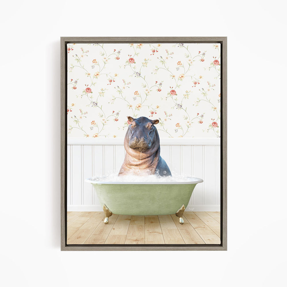 A hippopotamus sitting in a green bathtub filled with water, surrounded by a floral wallpaper.