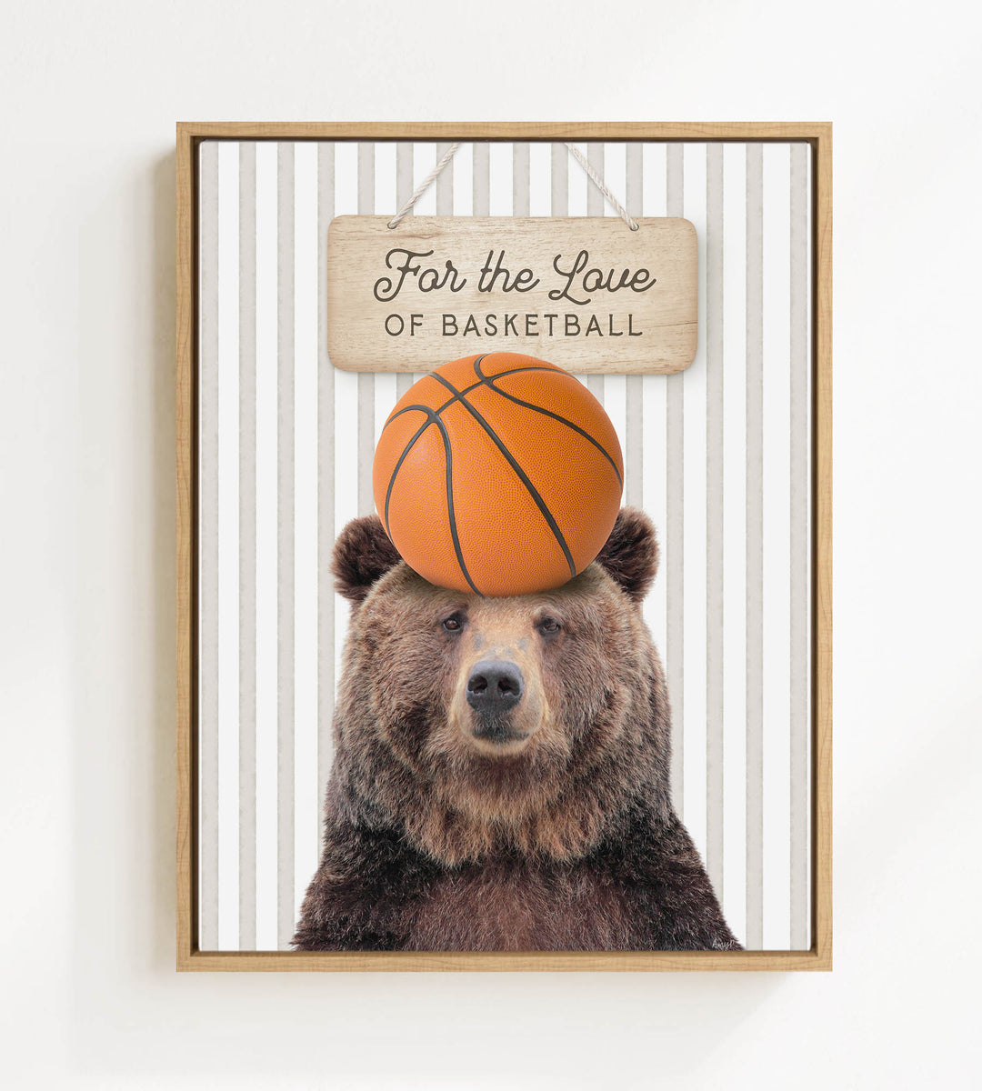 A framed image of a brown bear holding a basketball on its head, with a wooden sign above it that says "For the Love of Basketball".