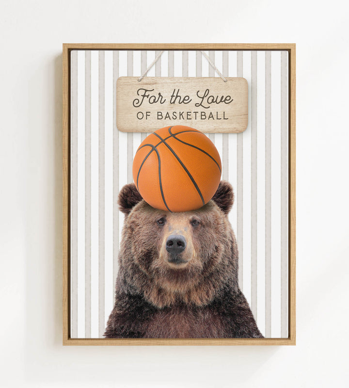 A framed image of a brown bear holding a basketball on its head, with a wooden sign above it that says "For the Love of Basketball".