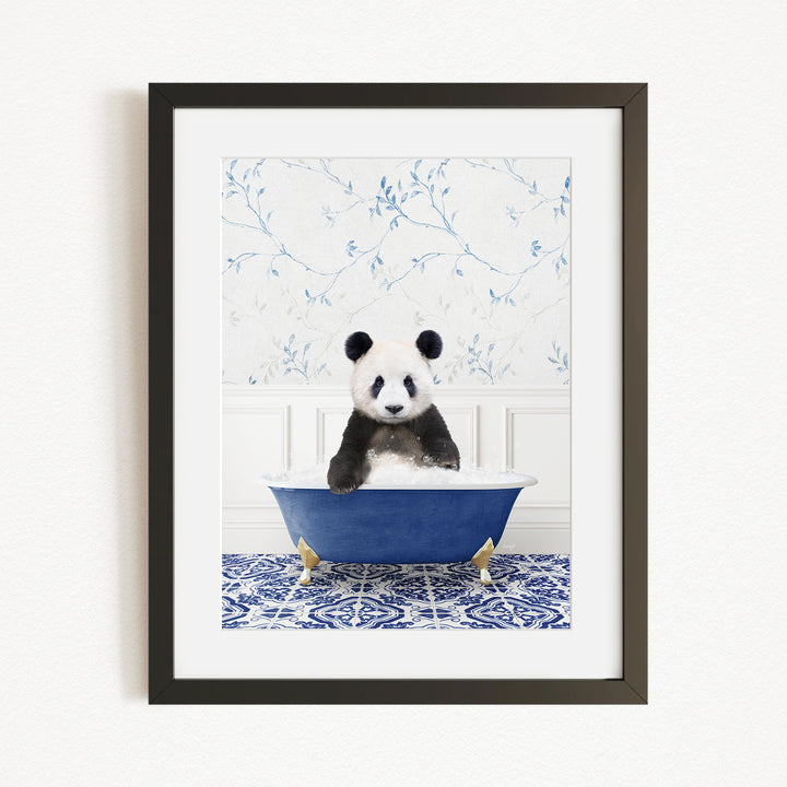 A panda bear sitting in a blue bathtub, surrounded by a blue and white floral patterned wall.