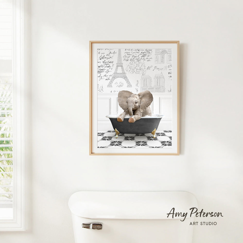 A framed image of a baby elephant sitting in a bathtub, surrounded by various architectural drawings and text.