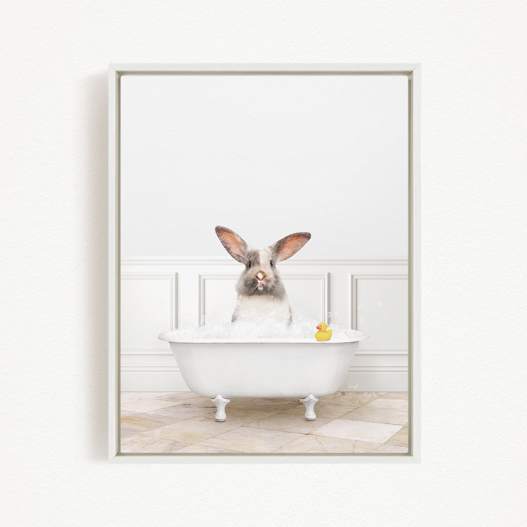 A white rabbit sitting in a white bathtub, with a rubber duck floating in the water.