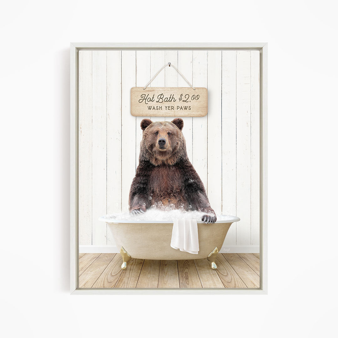 A brown bear sitting in a bathtub, with a sign above it that says "Hot Bath $2.00 WASH YOUR Paws".