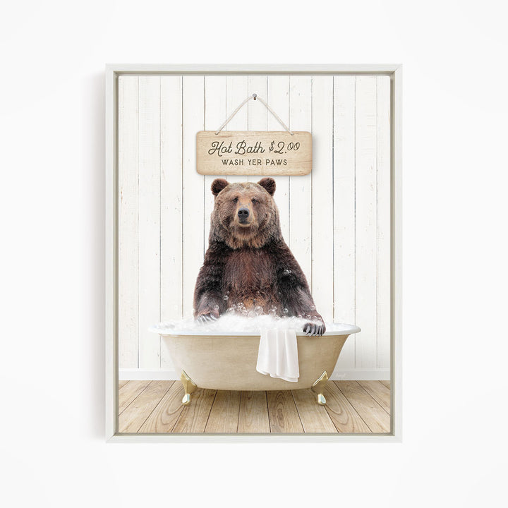 A brown bear sitting in a bathtub, with a sign above it that says "Hot Bath $2.00 WASH YOUR Paws".