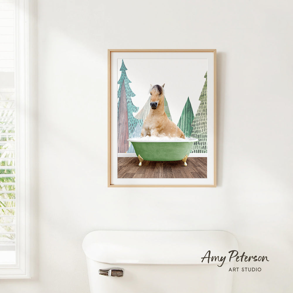 A framed image of a dog sitting in a green bathtub, surrounded by trees, is hanging on a white wall.