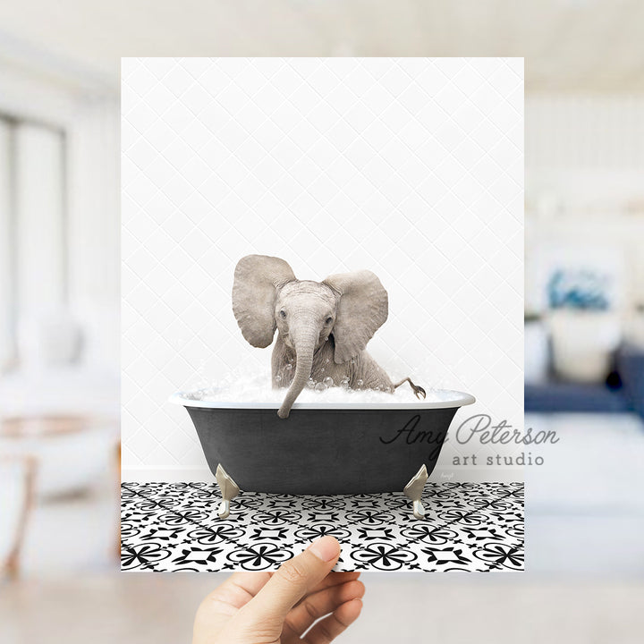 a person holding up a card with an elephant in a bathtub