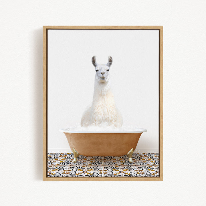 A white llama sitting in a bathtub filled with bubbles, with a patterned tile floor beneath it.